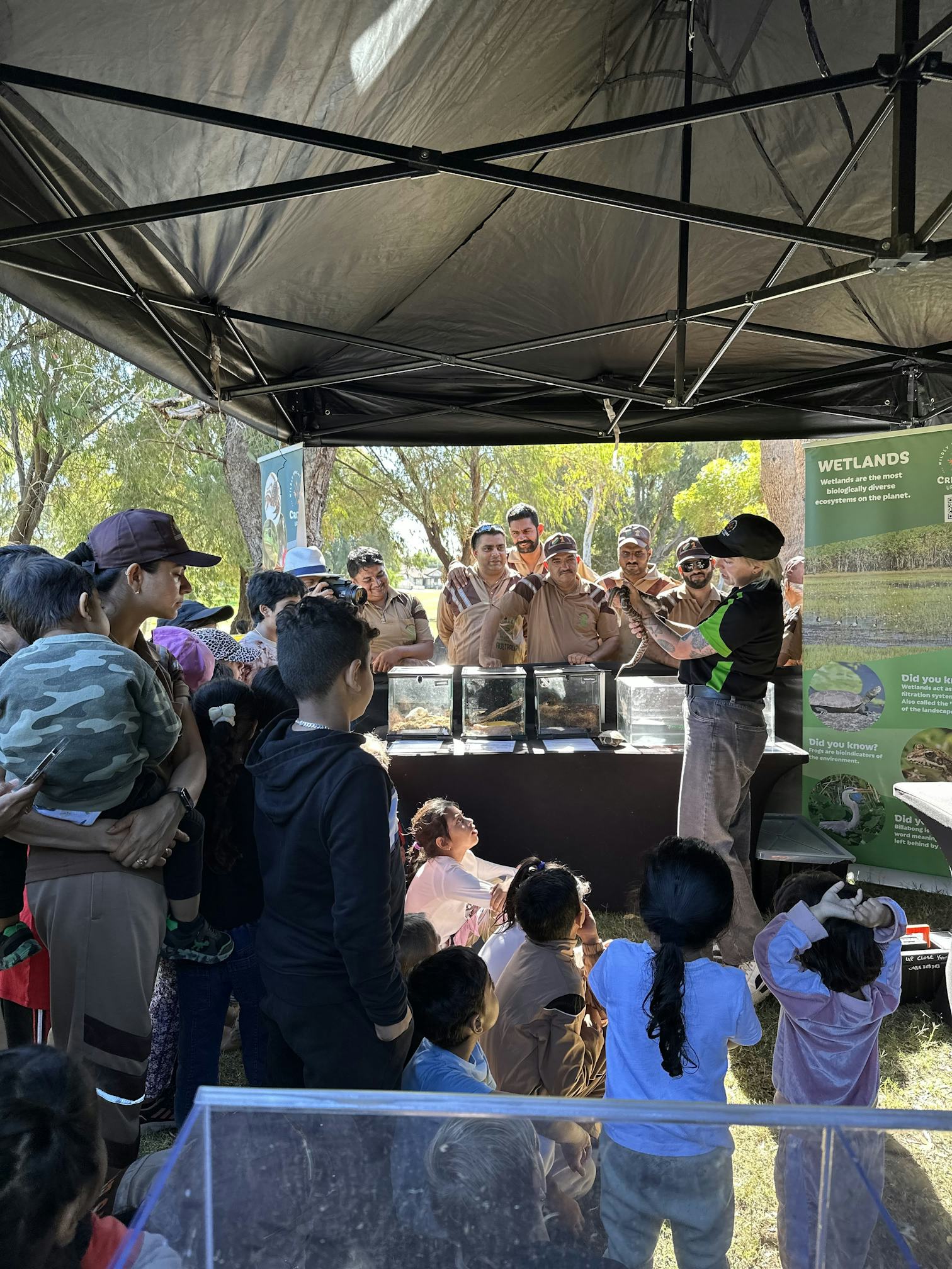 Volunteers enjoying a native animal show featuring Mocha the Stimson's Python. (Image: Conservation Volunteers Australia)