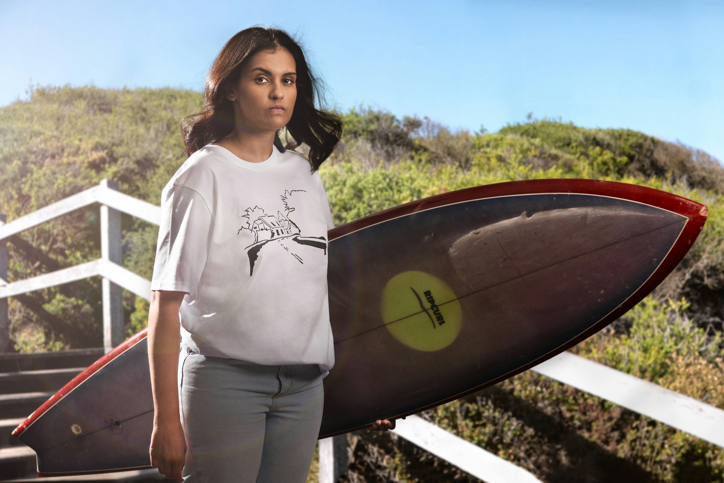 T Shirt design by Elly Chatfield (Gamillaroi), modelled by Shay McMahon (Eora), printed by Rip Curl. Image source: Deakin University